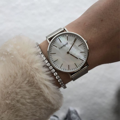 Elegant watch with mesh strap and natural mother-of-pearl dial